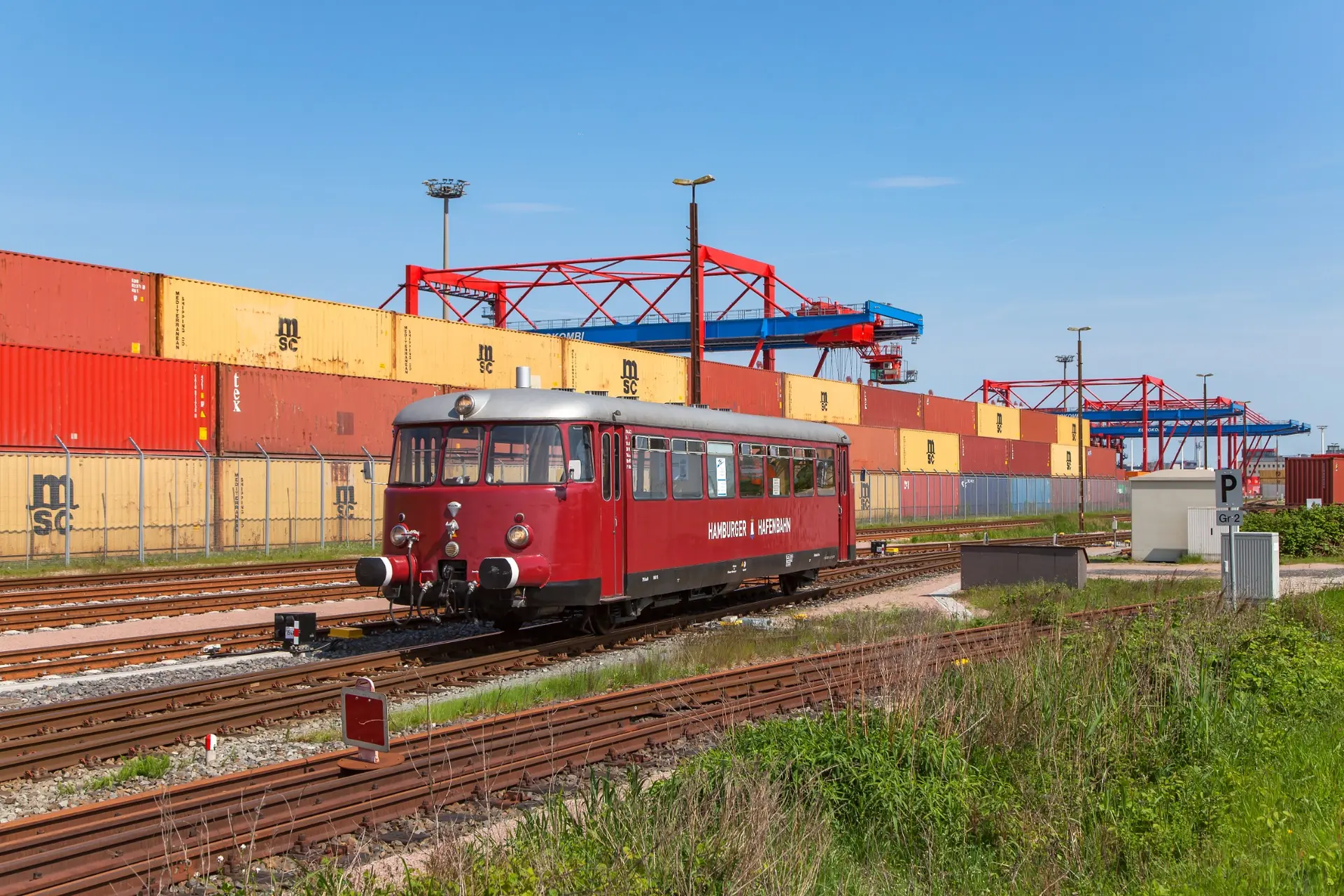 Vorbildaufnahme einer Rangierlok zwischen Gleisen und Industrieanlagen im Hafen